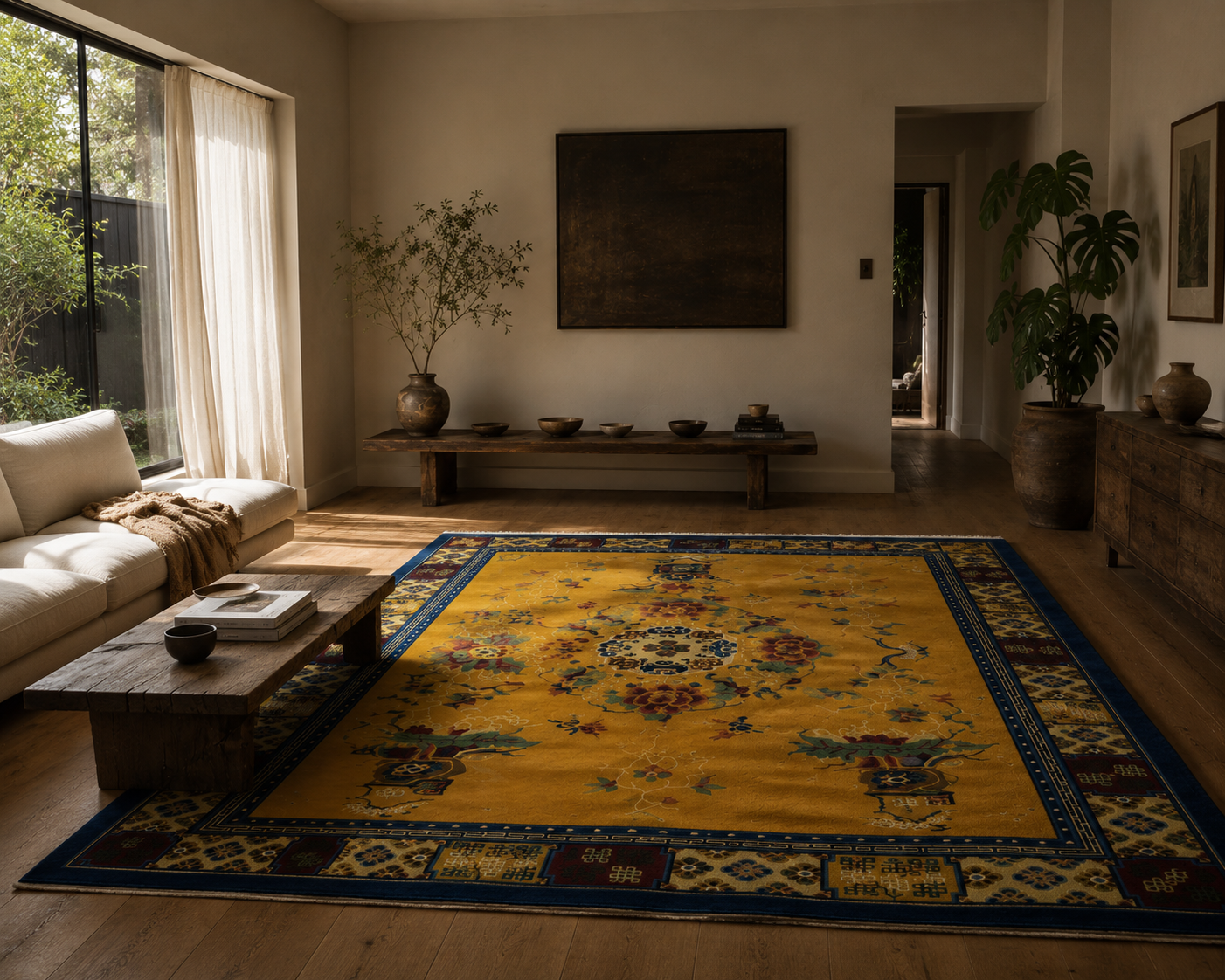 Living room with a large yellow rug featuring intricate patterns, a white sofa, wooden coffee table, and decorative items.